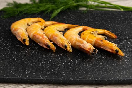 Delicious cooked shrimps on grey marble table krop in the back. Nice backgroundの写真素材