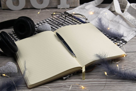 Leather handbag, clean blank notepad, pen, glasses, watch on a wooden background, top view. Free space for text.の写真素材