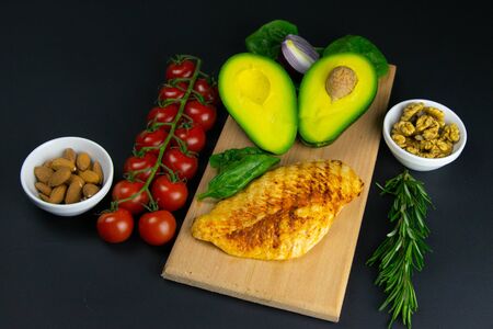 Ketogenic diet concept. A set of products of the low carb keto diet. Green vegetables, nuts, chicken fillet, flax seedsの写真素材