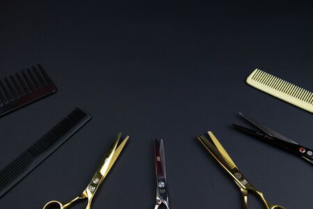 Composition of hairdressers instruments on black textured backgroundの写真素材