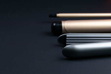 Composition of hairdressers instruments on black textured background