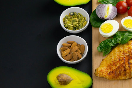 Ketogenic diet concept. A set of products of the low carb keto diet. Green vegetables, nuts, chicken...