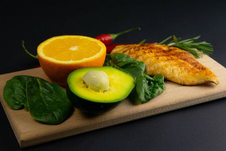 Ketogenic diet concept. A set of products of the low carb keto diet. Green vegetables, nuts, chicken fillet, flax seedsの写真素材