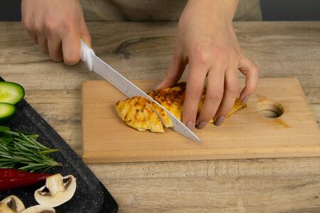 Chef cutting chicken fillet. Making Chicken and Egg Galette Series. Top viewsの写真素材