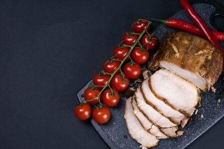 Grilled pork steaks and rosemary with hot paper and sauce on black stone background with allspice in different colors. Top view with copy spaceの写真素材