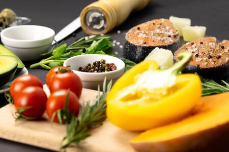 Tomatoes peppers and tomatoes in the background of salmon and spices beautiful flat layの写真素材