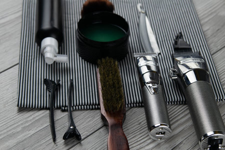 Flat lay from hairdressing accessories including: haircuts, scissors, combs, gels for styling and...