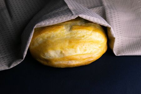 Homemade Bread on white towel under natural sun light. Front viewsの写真素材