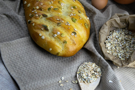 Concept shot of spice bread sticks with a wooden spoon on the wood table, oatmeal and a skein of bag...