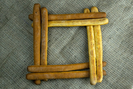 Pile of breadsticks or grissini square shape square view. Top views