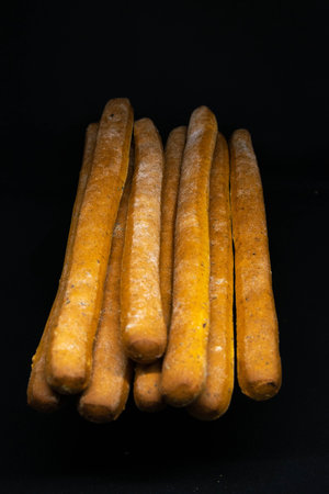 Breadsticks isolated on a black background. Top views