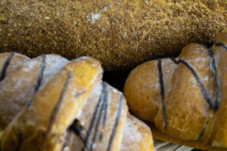 Different kinds of fresh bread with grain on black rustic background. Top views macro photography