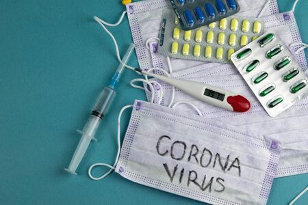 Coronavirus 2019-nCoV. Corona virus outbreaking. Epidemic virus Respiratory Syndrome. coronavirus mask, syringe, tablets and thermometerの写真素材