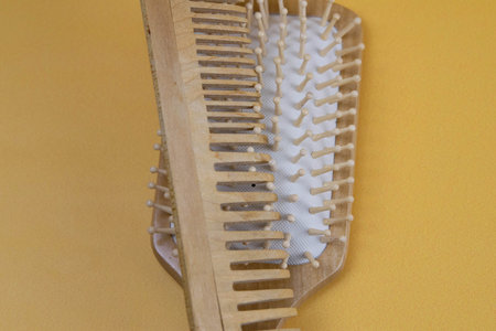 Combs on a towel that stands on an orange background. Close-up. Top view.