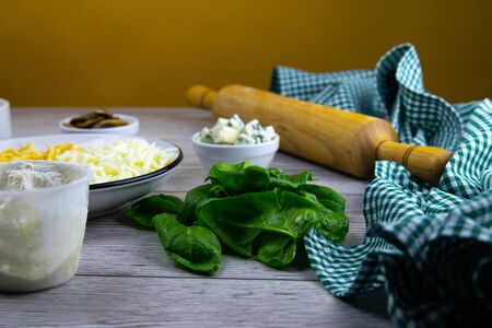 Free space in the center of the table. Fresh original italian raw pizza. Preparatory process. Top views with clear space.の写真素材