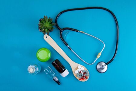 Medicine or pharmacy background. Laboratory table with a various drugs, reagents, stethoscope, syringe and jars abstract background. Flat layの写真素材