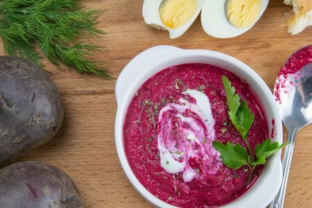 Delicious healthy beetroot salad with egg, cucumber, red and yellow peppers and avocado for dinner. Diet concept.の写真素材