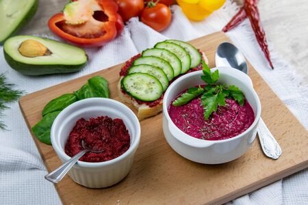 Delicious healthy beetroot salad with egg, cucumber, red and yellow peppers and avocado for dinner. Diet concept.の写真素材