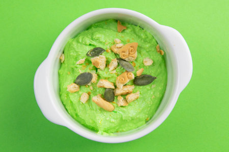 Curd with avocado and kiwi. Healthy eating concept. Assortment of products in bowls on green...