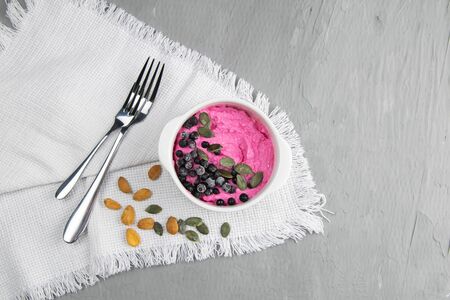 Cottage cheese with jam, fresh blueberries and pumpkin seeds in a ceramic bowl, closeup.の写真素材