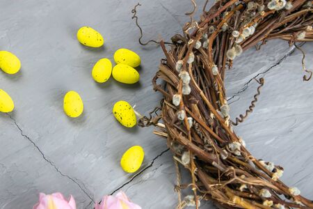 Easter willow wreath and blue Easter eggs on blue background. Top view, copy space.の写真素材