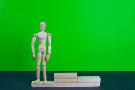 Full length portrait of male winner on winner's pedestal, on green background. The composition of 3 components: 3 place.の写真素材