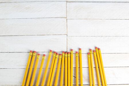 A set of orange pencils on a white wooden table. Printing supplies.の写真素材