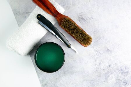 Shaving gel, towel, Comb and dangerous razor stand on a concrete background.の写真素材