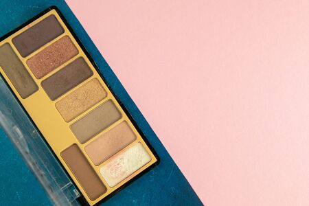 Colorful shades for make-up stand on a pink table. Top views. Flat lay styling. Copy space.の写真素材