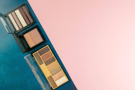 Colorful shades for make-up stand on a pink table. Top views. Flat lay styling. Copy space.の写真素材
