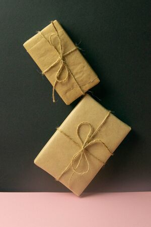 Banner with Wrapped in Eco craft holidays present gift boxes flower on pinc table top view. Flat lay stylingの写真素材