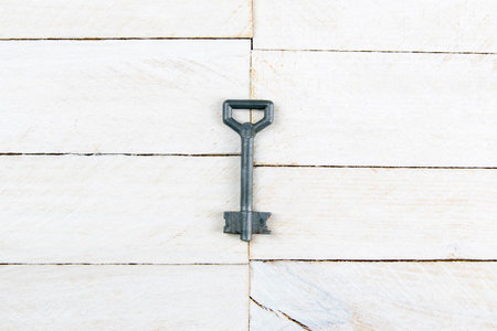 House-shaped key in the wooden table. Top views.