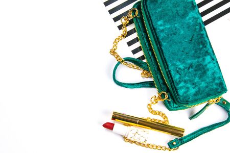 Tulips with green women's clutch and women's cosmetics on a white background.の写真素材