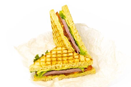 Sandwich with ham, cheese, tomatoes, lettuce, and toasted bread. Front view isolated on white background.の写真素材