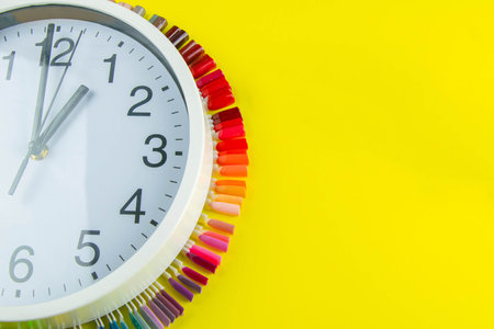 A set of cosmetic tools for manicure and pedicure on a blue background. The watch and palette of...