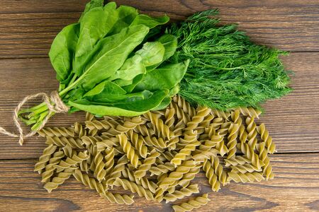 Top view of foglie spinach pasta on black wooden table. Top views,close-up.の写真素材
