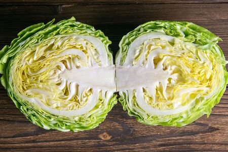 Ripe white cabbage on a wooden table. Top views, close-up.の写真素材