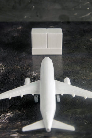 Airplane with wooden cubes on which you can enter your date stands on a dark background. Top views.の写真素材