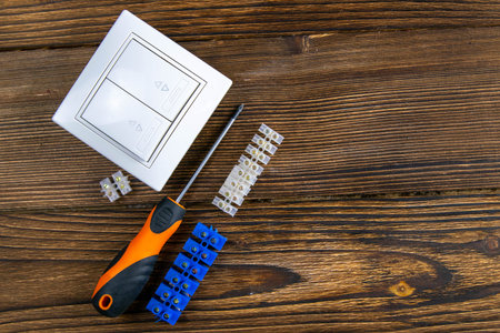 Tools of an electrician installer or Builder on a dark wooden table. The concept of making an...