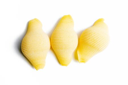 A few Conchiglie, seashells, pasta pieces isolated on white background.の写真素材