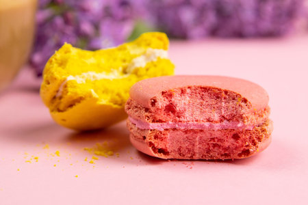 Two macaroons close-up and spring flowers, pastel background. Romantic morning, gift for beloved.