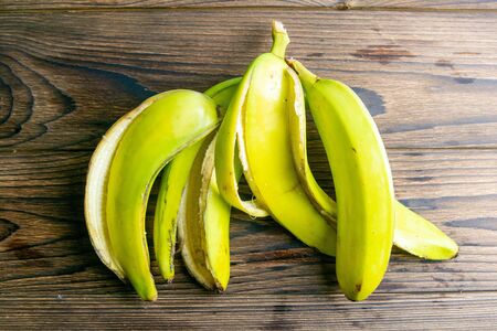 Skin of banana on a wooden table. Top views, close-up.の写真素材