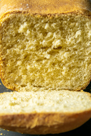 Fresh fragrant bread against a dark background. Assortment of baked bread on dark table background....
