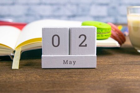 May 2 on the wooden calendar. The second day of the spring month, a calendar at the workplace. Spring. Close-up.の写真素材