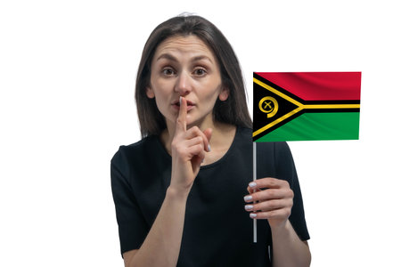 Happy young white woman holding flag of Vanuatu and holds a finger to her lips isolated on a white background.の写真素材