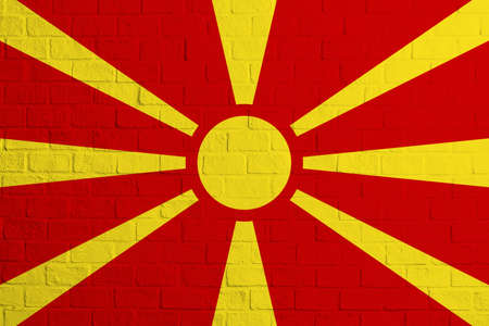 Flag of Northern Macedonia. Brick wall texture of the flag of Northern Macedonia.の写真素材