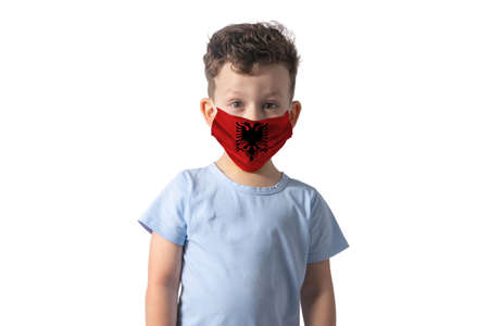 Respirator with flag of Albania. White boy puts on medical face mask isolated on white background.の写真素材