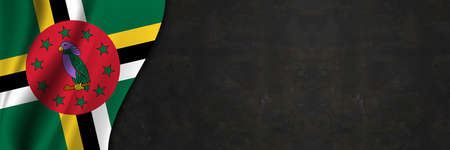 Dominica flag on concrete wall. Banner with fabric texture of the flag of Dominica.の写真素材