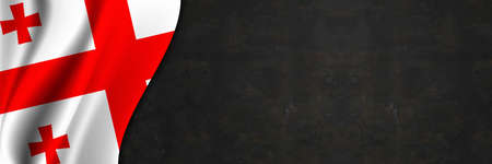 Georgia flag on concrete wall. Banner with fabric texture of the flag of Georgia.の写真素材