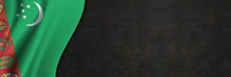 Turkmenistan flag on concrete wall. Banner with fabric texture of the flag of Turkmenistan.の写真素材